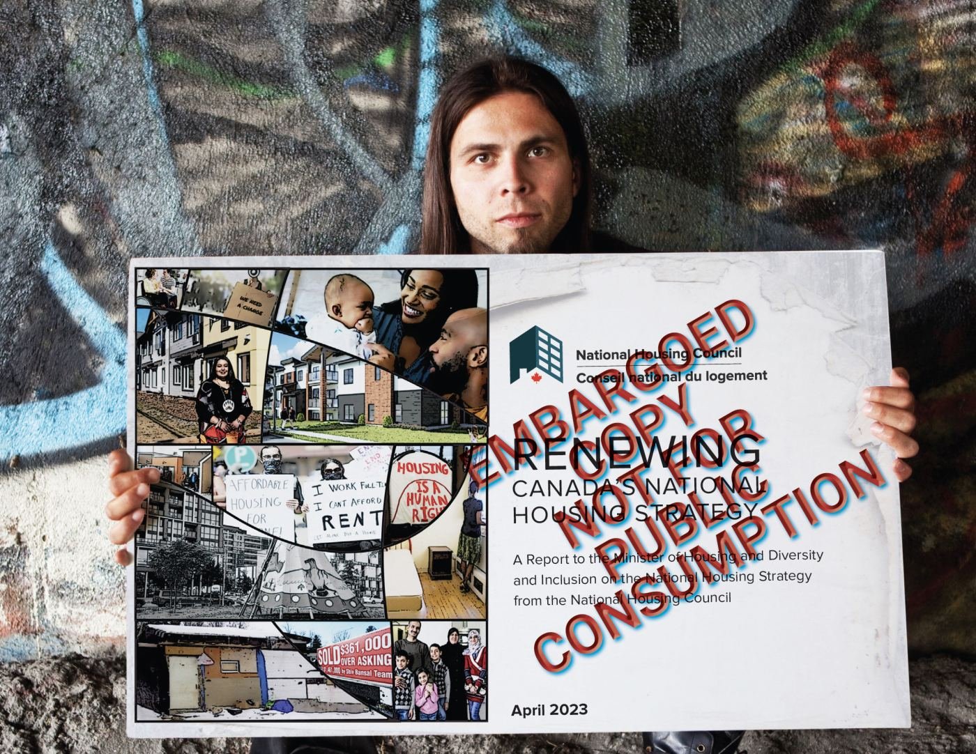 National Housing Council report held up against a graffiti wall